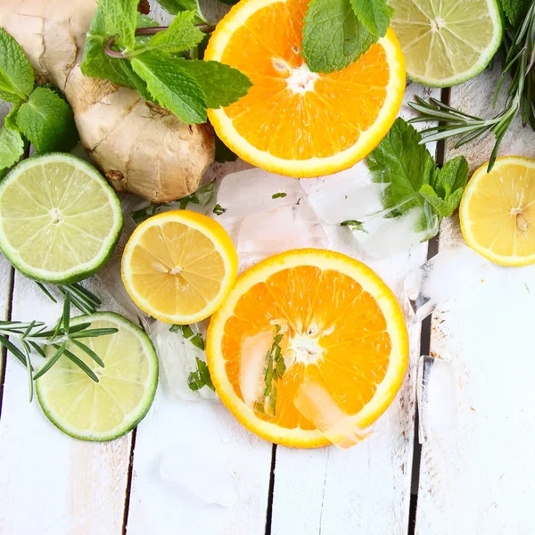 Lemon, lime and orange with mint and rosemary — Stock Photo, Image