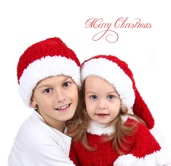 Cute girl and boy in Christmas hats with gifts — Stock Photo, Image