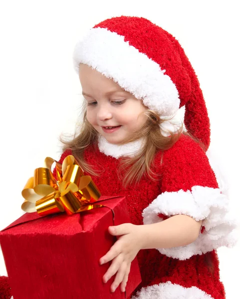 Cute little girl in a New Year's cap with a gift — Stock Photo, Image