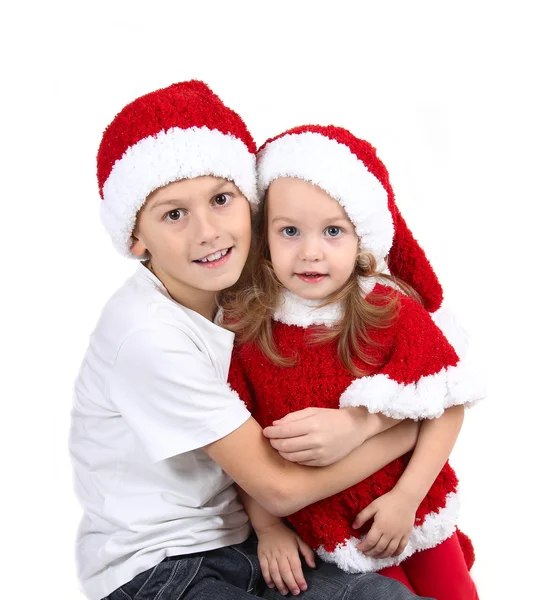 Cute girl and boy in Christmas hats with gifts — Stock Photo, Image