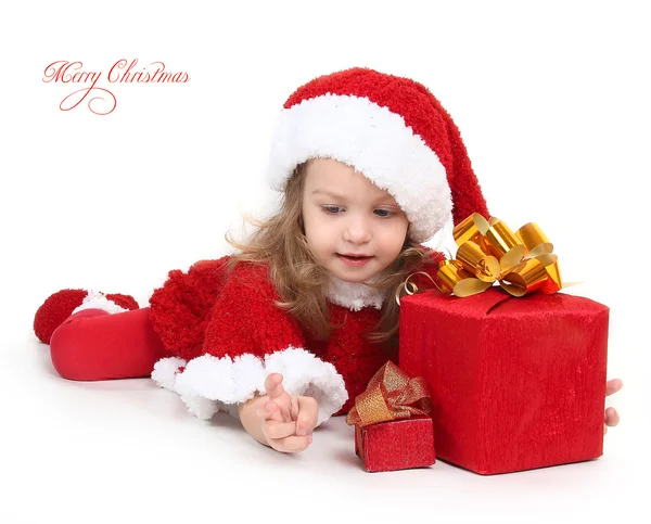 Cute little girl in a New Year's cap with a gift — Stock Photo, Image