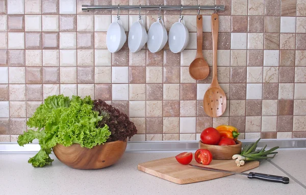 Cocina moderna con iluminación acogedora e ingredientes alimentarios en la encimera — Foto de Stock