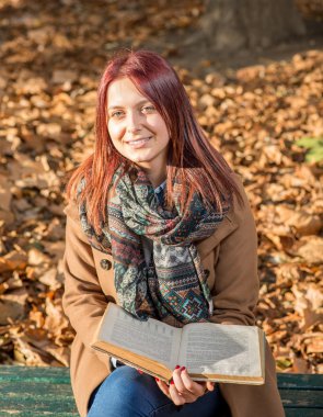 Mutlu kız parkta bankta oturmuş