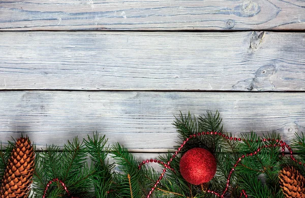 Cornice natalizia composta da rami di abete, palline e coni natalizi. Vista dall'alto — Foto Stock