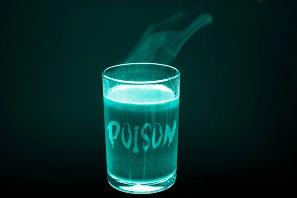 A glass with the inscription poison in x-ray light. A glass of dirty hot liquid — Stock Photo, Image