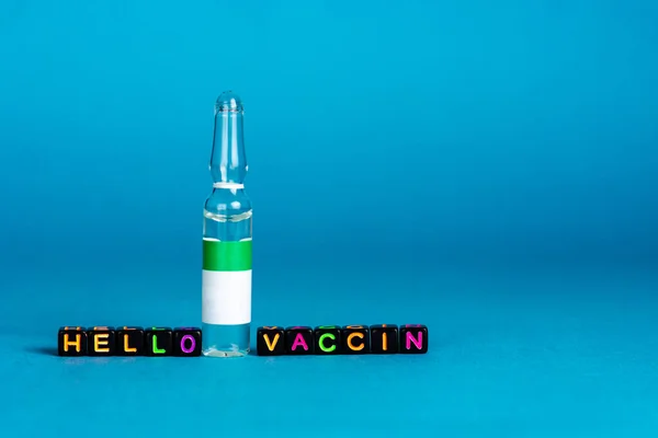 Medical ampoule, jar with pharmaceutical liquid, vaccine. Lettering of letters - hello vaccine — Zdjęcie stockowe