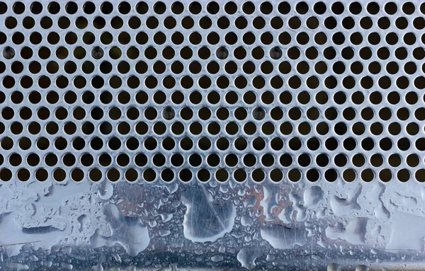 Wet metal surface. Perforated metal. Chrome plated surface.
