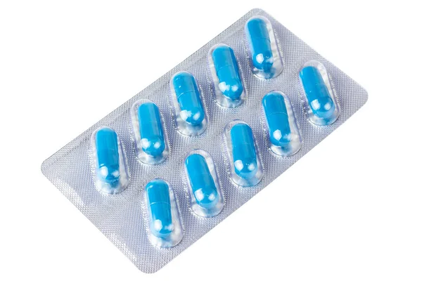 Blister pack dengan latar belakang putih. Kapsul biru. Pil medis. Terisolasi di atas putih. — Stok Foto
