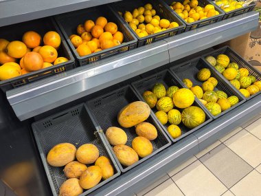 Assorted fruits on grocery store display shelves. Suitable for a wide range of uses