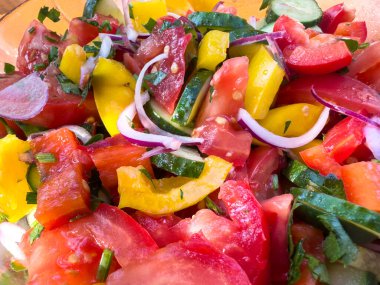 Colorful vegetable salad with tomatoes, peppers, and onions. Suitable for diverse creative needs