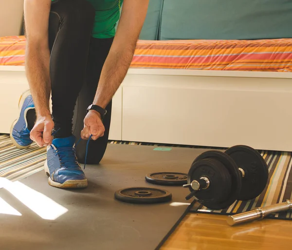 Home Fitness man Training With Weights On the floor