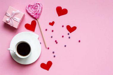 Romatik günaydın. Sade kahve, lolipop ve pembe arka planda bir kutuda hediye. Anneler Günü, Kadınlar Günü, Sevgililer Günü 'nü kutlarım. Metin için yer.
