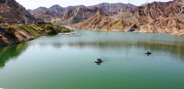 Beautiful view of the turquoise waters of Al Rafisah Dam , a lake surroundings by rocky mountain, Khorfakkan, United Arab Emirates.