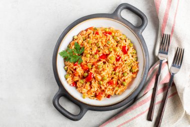 Djuvec rice - traditional balkan dish. Rice cooked with red bell pepper, tomato, peas and paprika. clipart