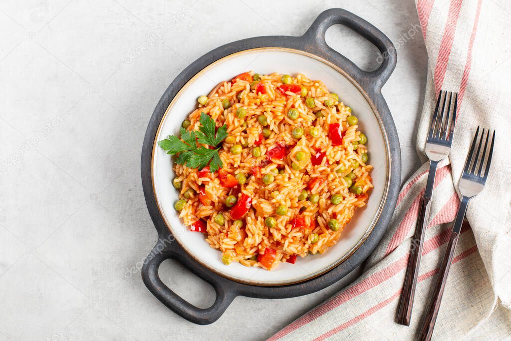 Djuvec rice - traditional balkan dish. Rice cooked with red bell pepper, tomato, peas and paprika.