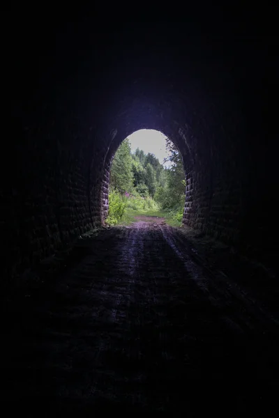 leaving the dark tunnel into the sun-lit nature