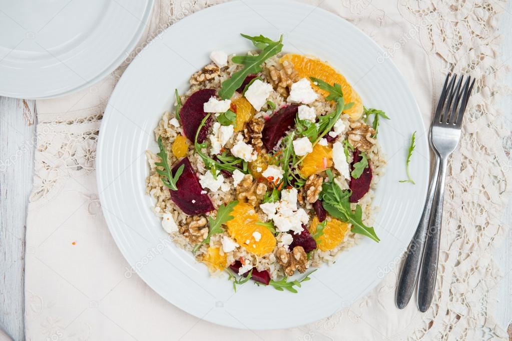 Warm Healthy quinoa, brown rice, cooked beetroot and orange sala
