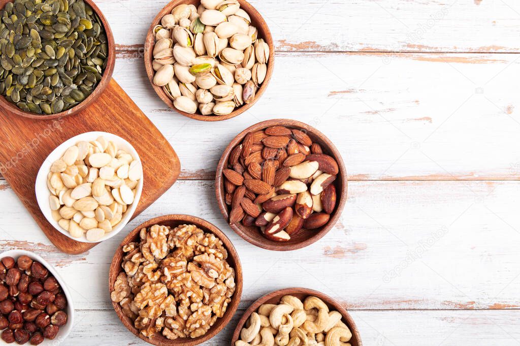 Different kind of nuts in wooden bowls