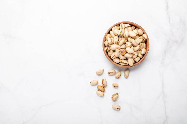 pistachios nuts in wooden bowl