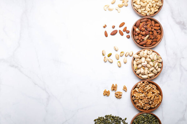 Different kind of nuts in wooden bowls