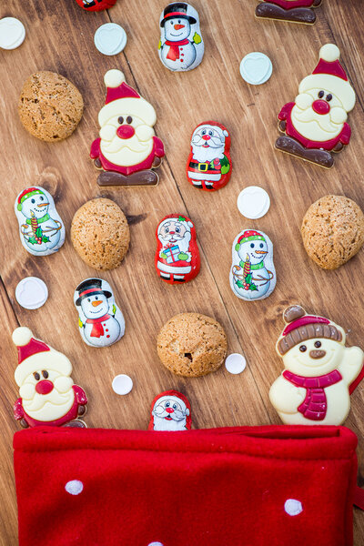 Chocolate Santas, Snowman and Biscuits near Christmas Stocking