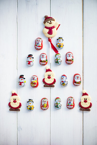 Chocolate Santas, Snowman and Biscuits laying in a form of Chris