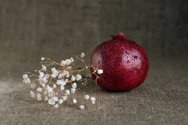 Çuval bezi arka planında çigila bulunan sulu nar meyvesi (garnet).