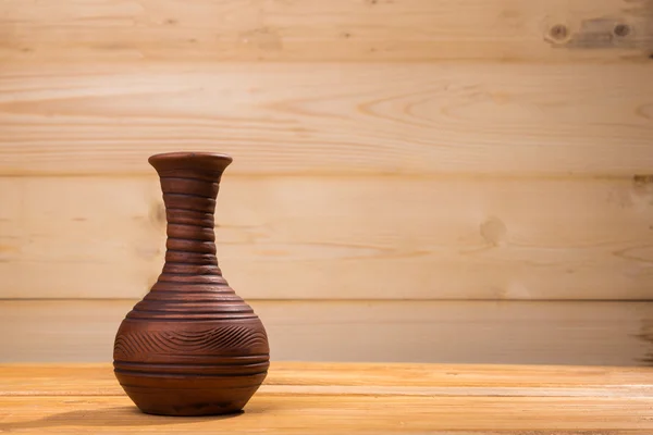 Botella de cerámica sobre fondo de madera . — Foto de Stock