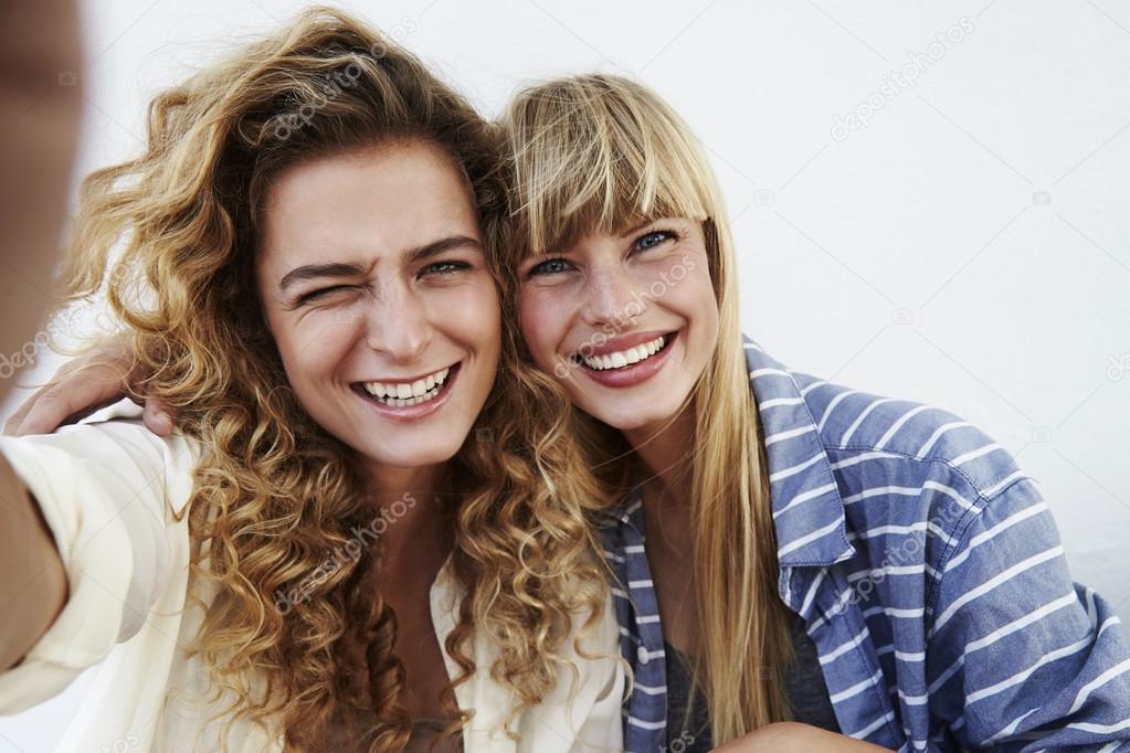 Two best friends teenage girls together having fun, posing emoti Stock  Photo by ©iordani 200335384