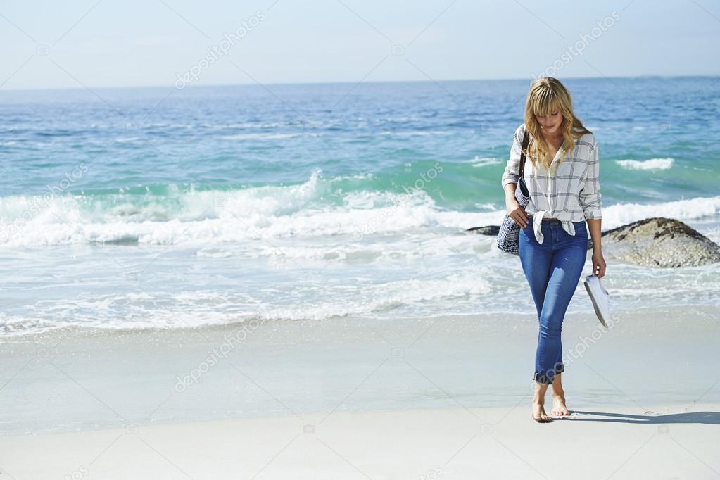Beautiful woman walking on beach