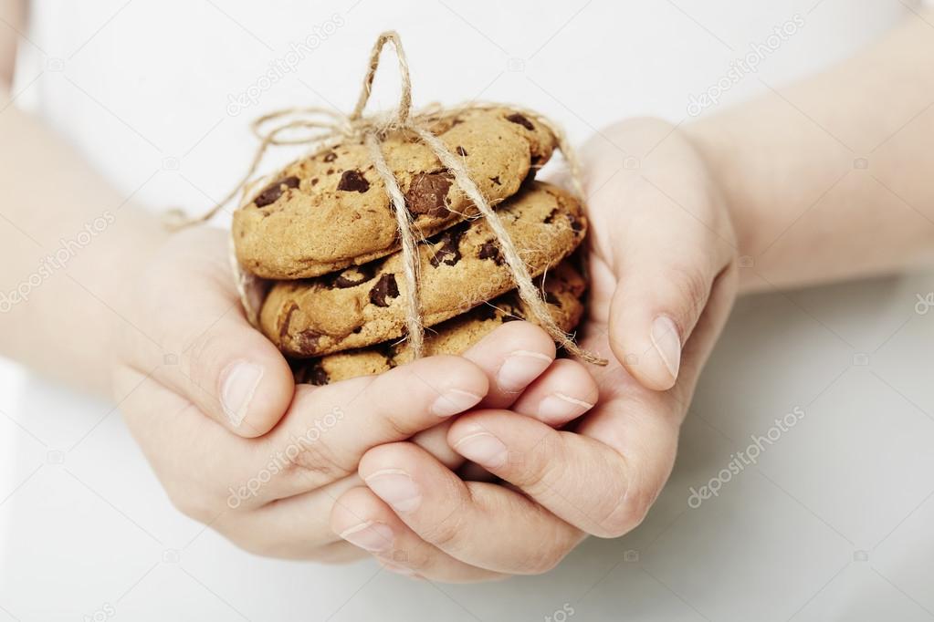 Boy holding chocolate chip cookies