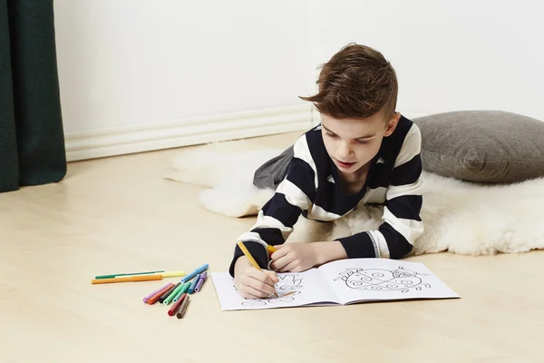 Boy with coloring book — Stock Photo, Image