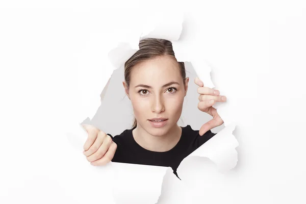 Woman emerging from paper — Stock Photo, Image
