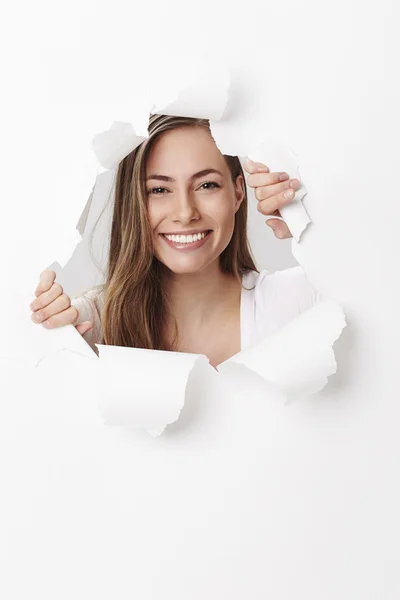 Woman smiling through tears in paper — Stock Photo, Image