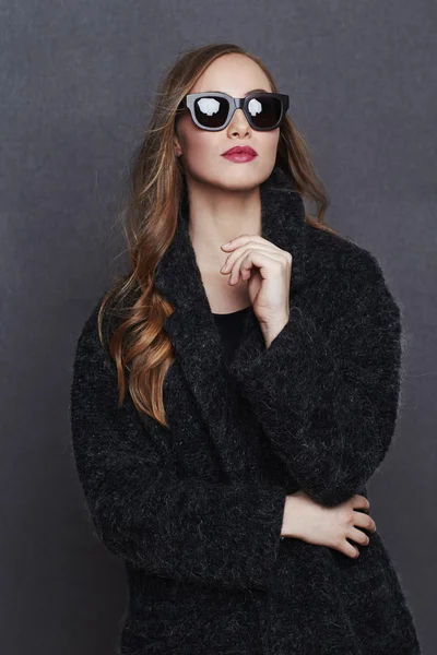 Young woman in fashionable black coat — Stock Photo, Image