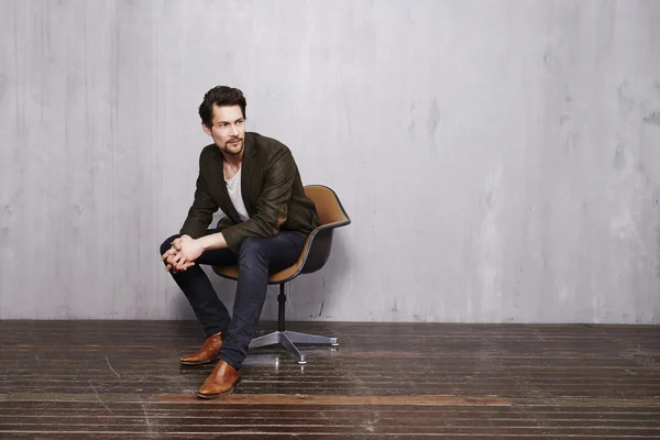 Handsome young man in chair — Stock Photo, Image