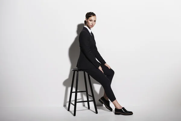 Businesswoman sitting on stool — Stock Photo, Image