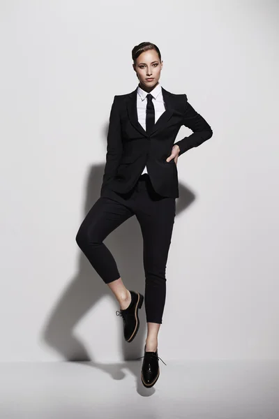 Posing businesswoman in cool black suit — Stock Photo, Image