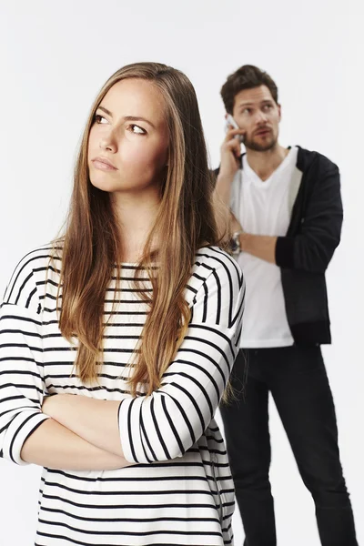 Sullen girl ignored by boyfriend — Stock Photo, Image