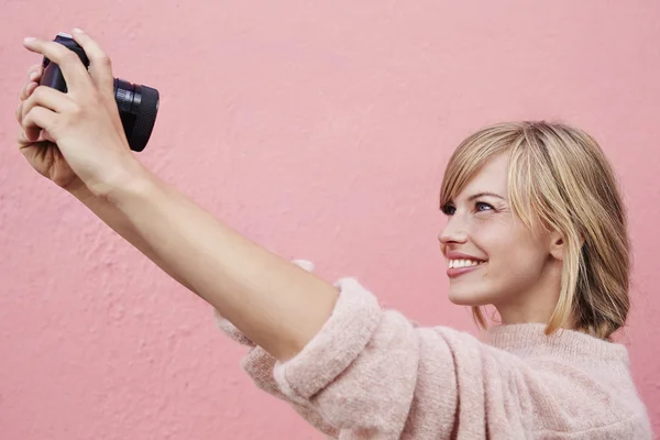 Женщина делает селфи с камерой — стоковое фото