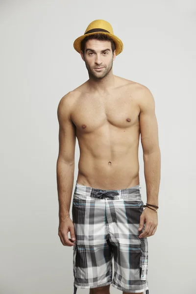 Man in shorts and hat posing — Stock Photo, Image