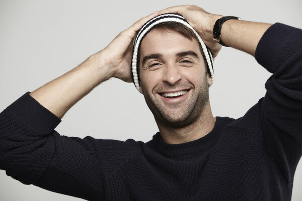 man in woolly hat smiling