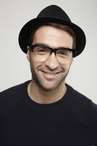 man in trilby smiling