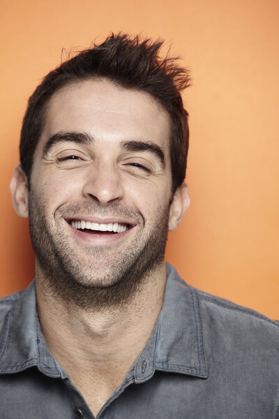 Mid adult man laughing