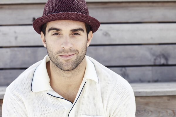 Man in red trilby smiling
