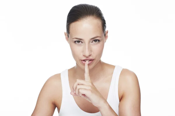 Frau mit Finger auf den Lippen — Stockfoto