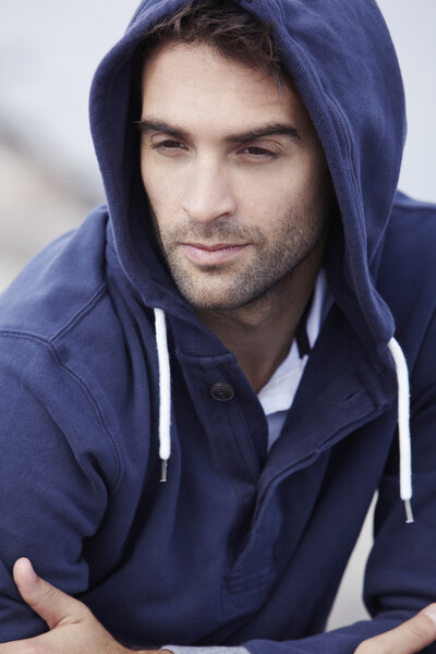 man wearing hooded top posing
