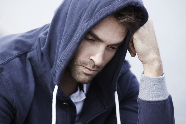 Man wearing hooded top posing