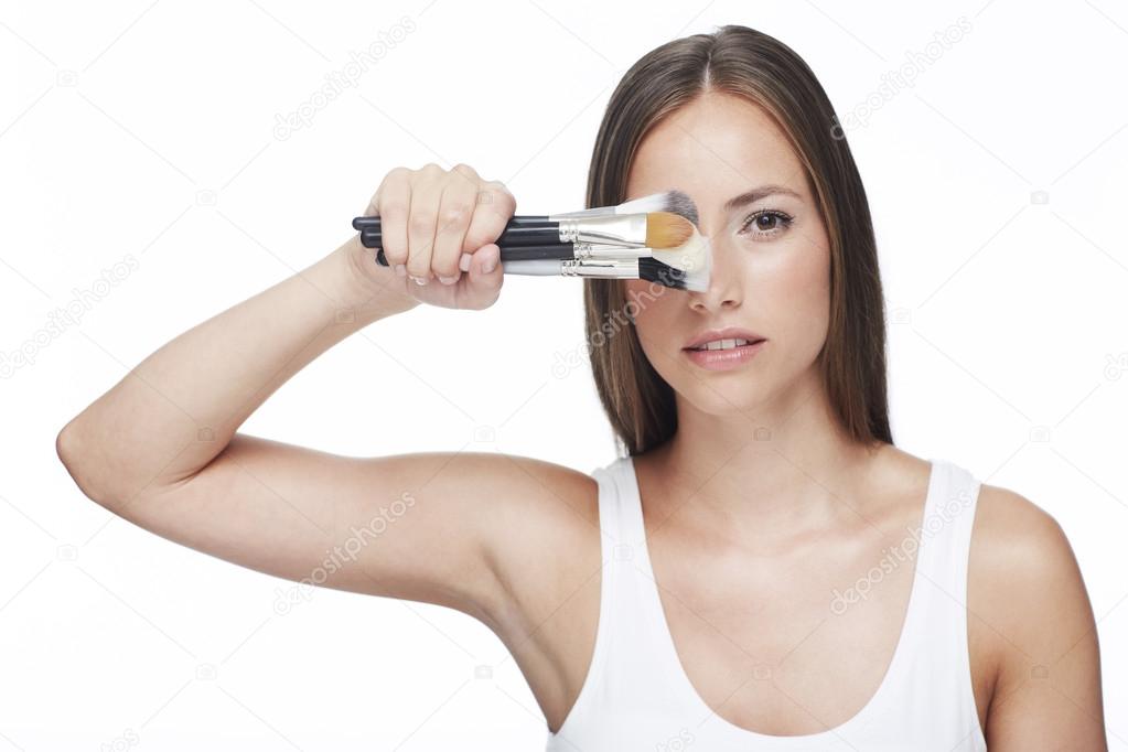 Woman holding make-up brushes
