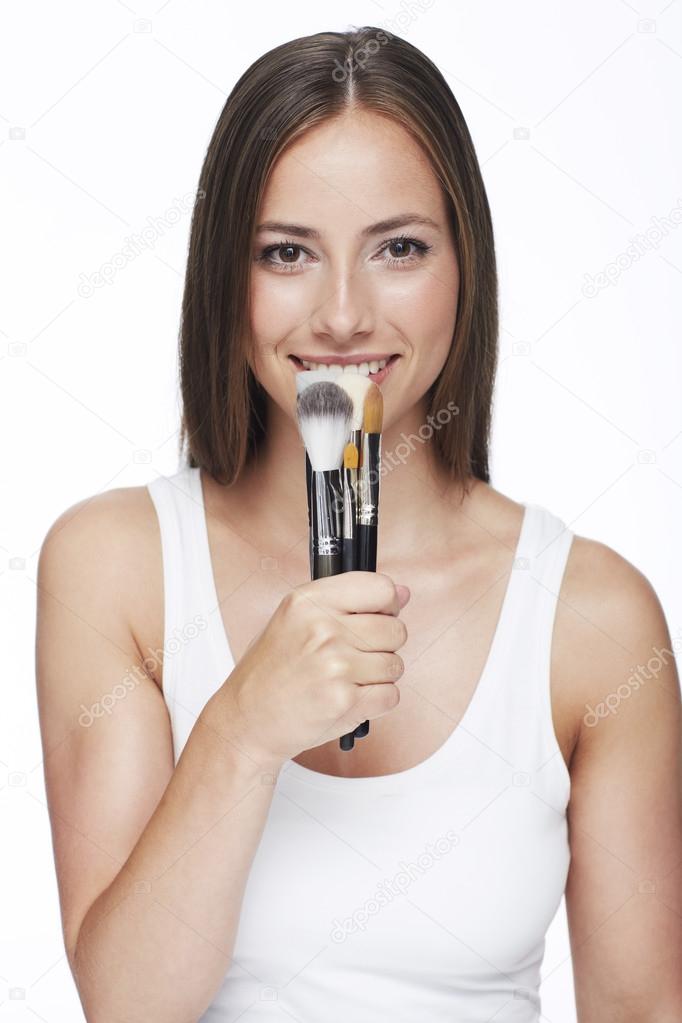 Woman holding make-up brushes